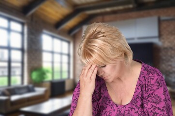 Unhappy old woman sit at home feeling depressed