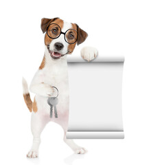 Smart Jack russell terrier puppy wearing eyeglasses holds in his paw the keys to a new apartment and shows empty list. Isolated on white background