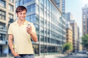 Young successful man walking in the street outside