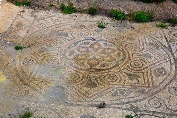 Remains of old colored mosaics on floor of ruined building in Turkish city of Arykanda. Art of...