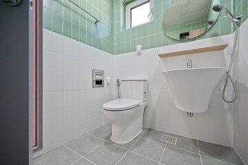 Fototapeta na wymiar A small and cute bathroom with mint-colored tiles
