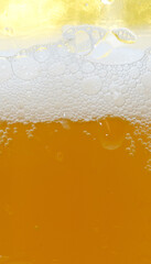 foam of fresh light beer with bubbles close-up