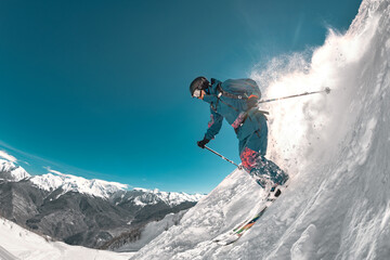 Freeride professional skier jumps at off-piste ski slope. Extreme sports at ski resort