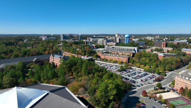 UNC Chapel Hill campus revealing Dean E. Smith Center for basketball on University of North Carolina. Aerial reverse shot.