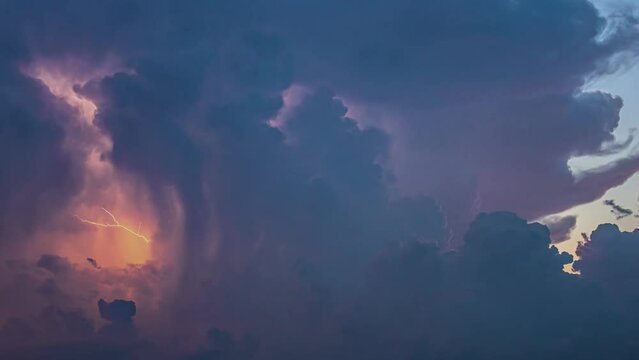 A Lightning Spark Flashing On A Moving Cloud In The Colourful Sky At Twilight