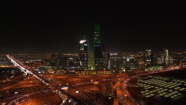 king Abdullah Financial Center in Riyadh city at night with high traffic street.