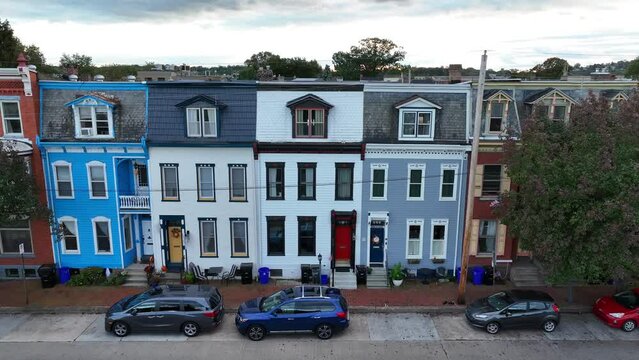 Colorful row houses in American city. Cinematic aerial establishing shot.