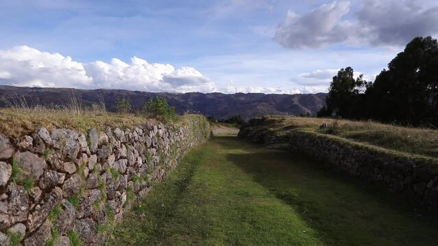Grassy Inca Road With Stone Retaining Walls Near The Kusilluchayoc - El templo de los monos In Cusco, Peru. - tilt up shot