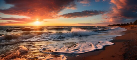 Stormy conditions along the Baltic sea shore reveal a stunning sunset sky with glowing clouds, golden sunlight, crashing waves, and a picturesque panoramic view of the seascape and cloudscape