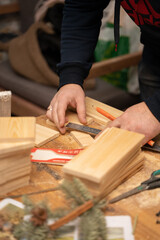A man saws boards. Wooden products