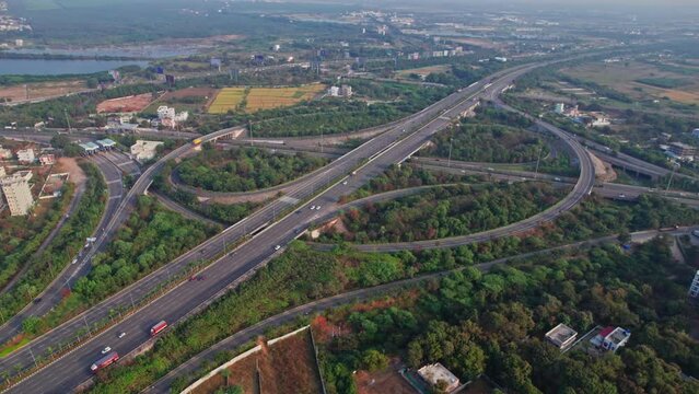 Spectacular Turning Overhead Shot of nehru outer ring road Highway showing multiple Roads, Bridges, Viaducts with little car traffic in hyderabad, telangana, india on Beautiful Sunny Day