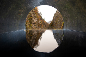 Kiyotsu Gorge Tunnel of Light with water reflection and forest mountain landscape view famous...