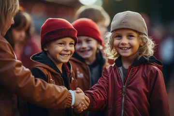 Tuinposter Children shaking hands and greet each other after sport game. © Degimages