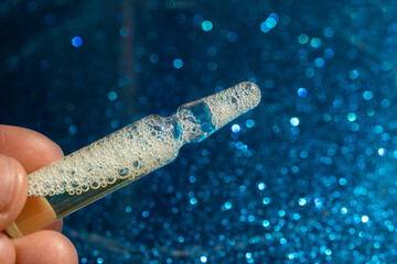 Ampoules with medicine in hands