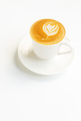 A cup of hot coffee latte with latte art on white table