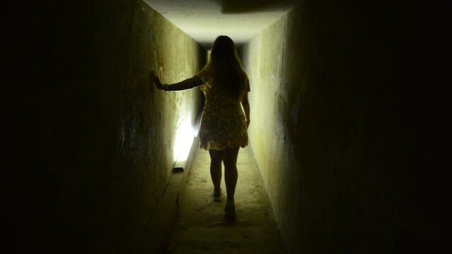 Tourist girl walks inside great pyramid of Gyza tunnel in Egypt. Woman in Cave. Slow motion