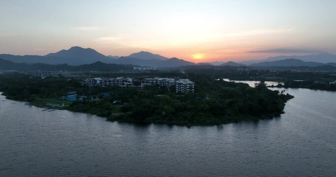Aerial footage of sunset over lake and mountains