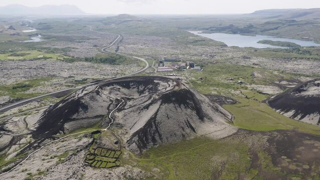 Drone circling the large Grabrok crater in Iceland on a cloudy day in summer in the land of fire and ice