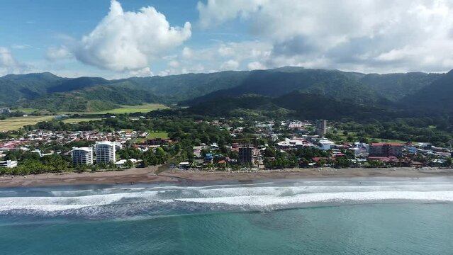 Beautiful drone shot flying over the black sand beach in Jac&oacute;, Costa Rica.