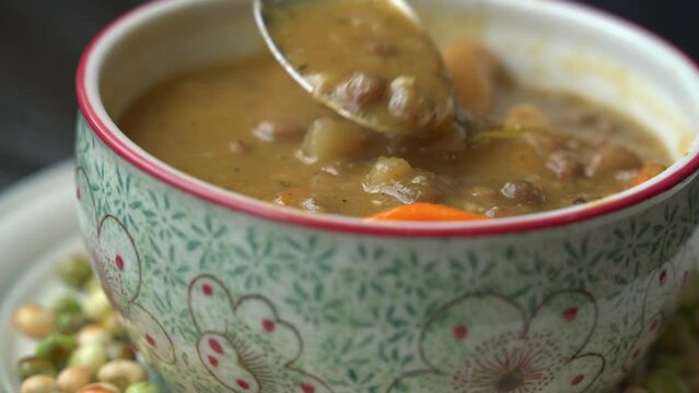 spoon dipping soup Preparing jamaican gungo pea soup after being picked from tree healthy green fresh protein cultivation harvested