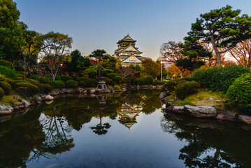 Fototapeta na wymiar Osaka castle in twilight, landmark of Osaka city on clear blue sky background.
