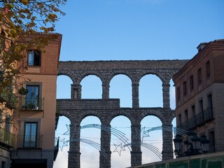 Fototapeta na wymiar To the north of Madrid lies the absolutely picturesque city of Segovia, Spain. It makes the perfect day trip from Madrid to wander its quaint streets and admire its incredible Roman aqueduct