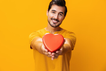 Man romance concept portrait shape happy studio yellow gift valentine romantic smiling love heart