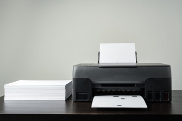 Printer with paper on gray background close up