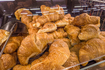 Croissants in self-service display for sale in supermarket