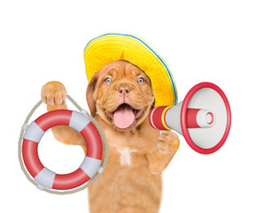 Happy mastiff puppy wearing summer hat screaming into a megaphone and showing lifebuoy. Isolated on...