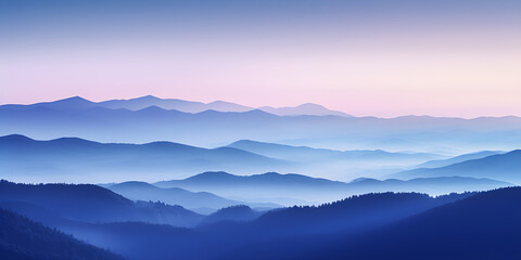 A silhouette of a mountain range with the first light of dawn breaking behind it illuminating the sky in soft pastels
