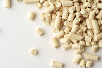 Wooden filler for cat litter box isolated on white background close up