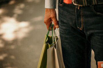 Close up on a man hand holding a shopping bags