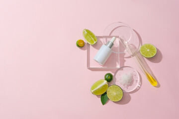 An unlabeled serum jar, fresh lemons and glassware are displayed on a pastel background. Creative space for cosmetic advertising. Vegan cosmetic concept.