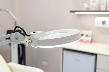Cosmetic lamp magnifier close up in the office of a dermatologist in a cosmetology clinic