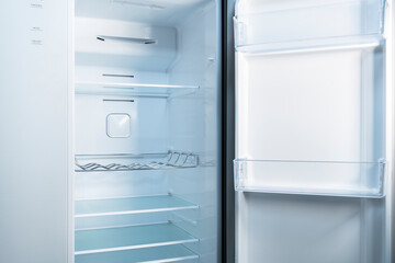 Empty refrigerator with open door Inside an empty, clean refrigerator, a refrigerator compartment after defrosting