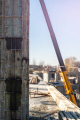 View of a large construction site with buildings under construction and multi-storey residential homes.Tower cranes in action on blue sky background. Housing renovation concept. Crane during formworks