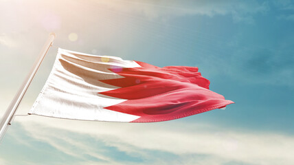 Bahrain national flag waving in beautiful sky. The symbol of the state on wavy silk fabric.