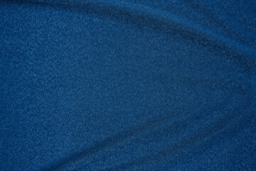 Trendy 80s, 90s, 2000s Background of draped dark blue fabric with silver lurex thread. Beautiful...