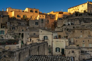 Fototapeta na wymiar close-up view of the old city center of Matera with the stone houses in the last rays of sunlight