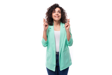 Fototapeta premium young pretty curly brunette employee of a business company woman dressed in an office blue jacket