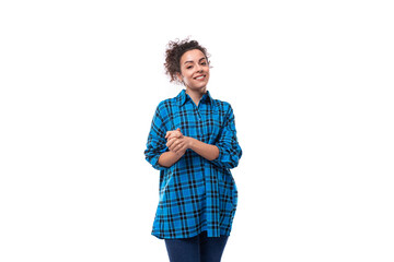 young kind curly brunette woman in a blue plaid shirt on a white background