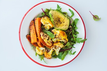 Warm winter salad with roasted cauliflower, sweet potato and avocado.