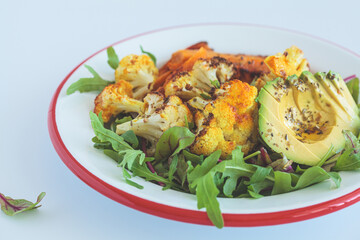 Warm winter salad with roasted cauliflower, sweet potato and avocado.