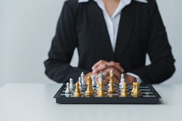 young businessman Asian man sitting holding hands looking at a chess set Business strategy concepts, business plans, teamwork Success management or leadership concept.