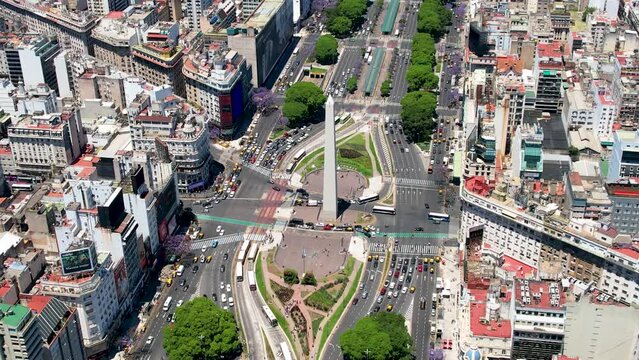 Beautiful aerial footage of the 9 of July avenue, the Republic plaza the landmark Obelisk and the impressive architecture of buildings in the city of Buenos Aires, Argentina 