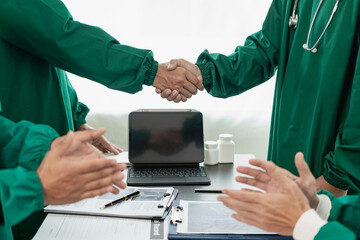 Researchers with medical experience shaking hands after successful medical conference, dedicated to...