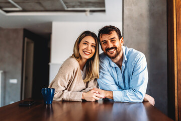 Portrait of multiethnic couple embracing and looking at camera. Happy people concept.