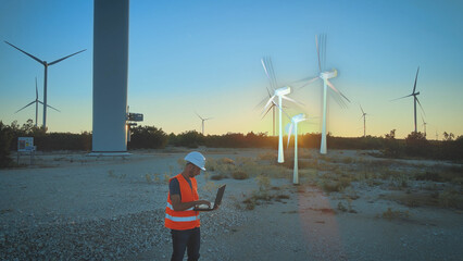 Construction worker at windmill park field planning new digital wind turbine © TechAnimationStock