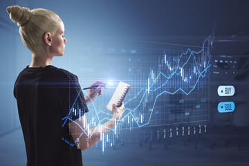 Attractive blonde woman with notepad using creative candlestick trading graph on blurry office...
